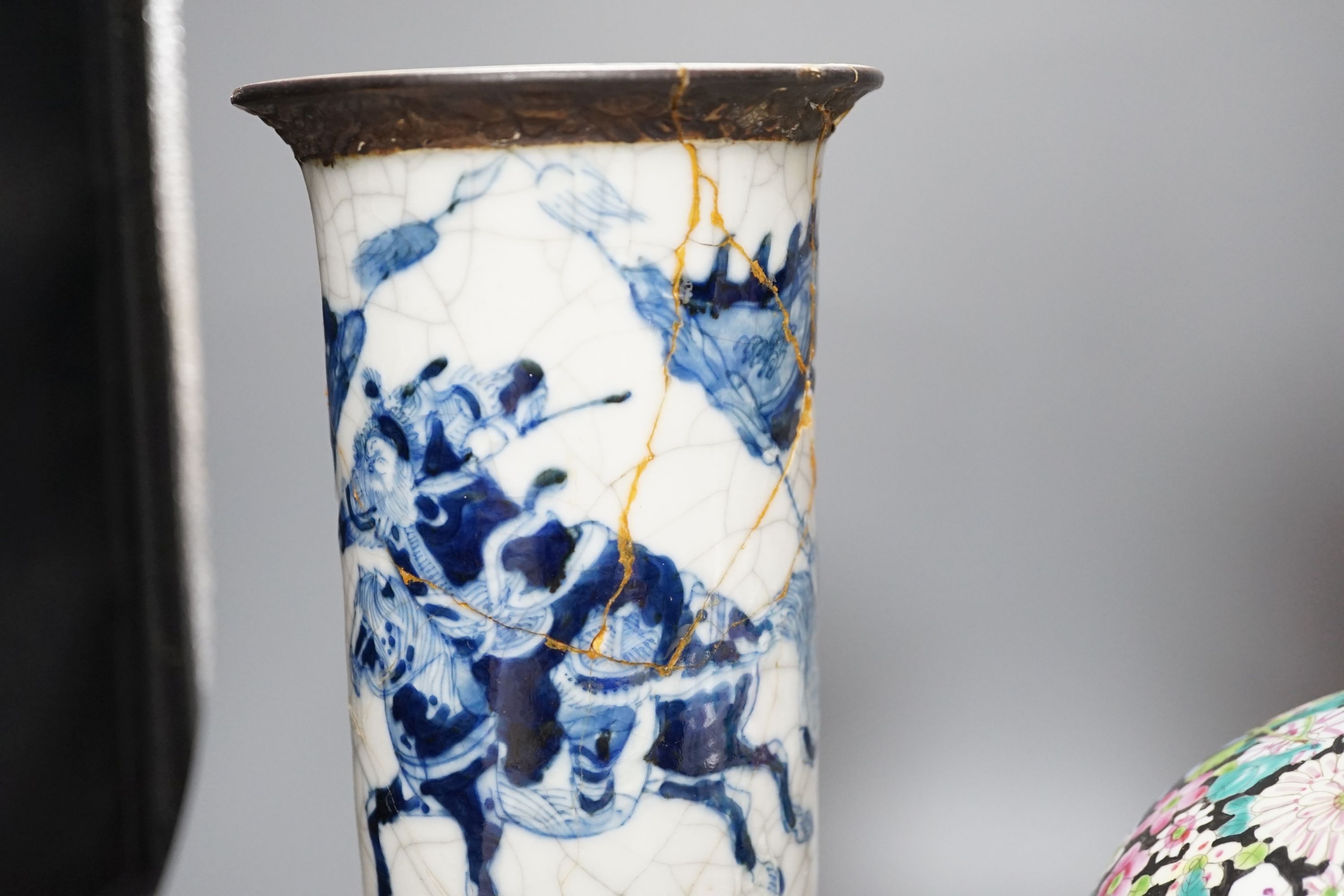 An early 20th century Chinese famille rose thousand flowers bottle vase (restored) together with a Chinese blue and white crackle glazed sleeve vase (a.f)., tallest 40cm